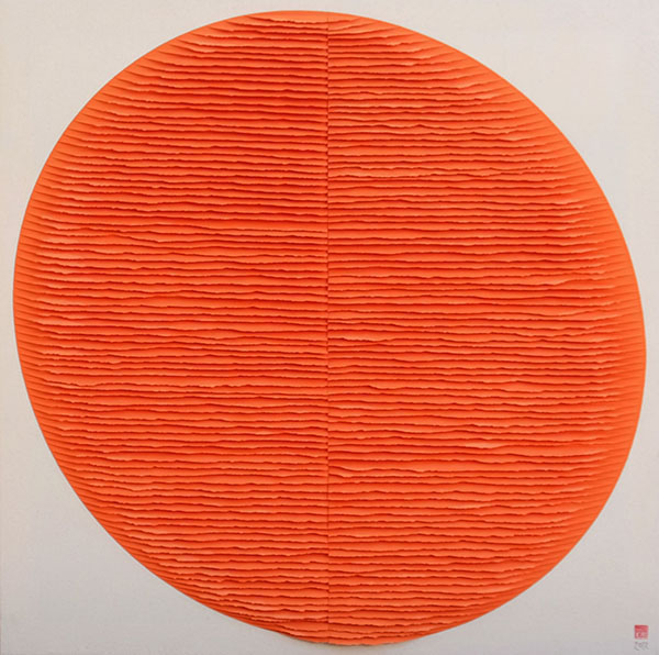 An artwork by Fernando Daza that uses layers of bright orange paper in a circular form.