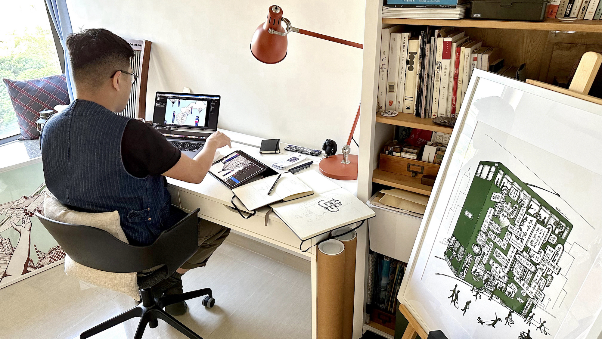 Rick Lo working on his artwork using two tablets in his studio, showing a work of tram by Rick Lo by side