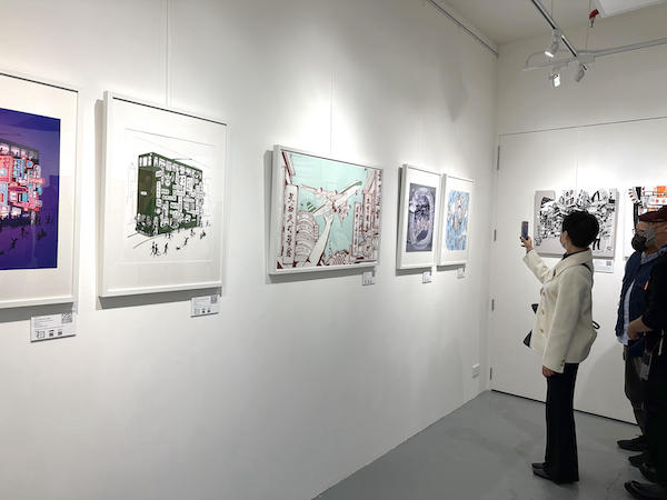 Visitors taking pictures of Rick Lo's artworks in a exhibition at Hong Kong Arts Collective gallery 