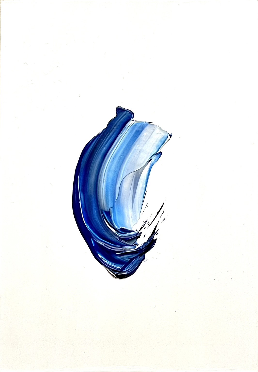 On a white background, a paint paste with different shade of blue and white