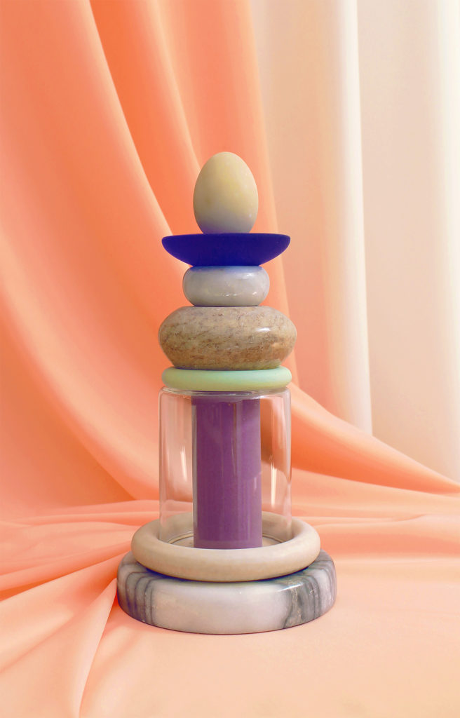 A sculpture that is formed from stacked polished marble and plastic circular forms. 