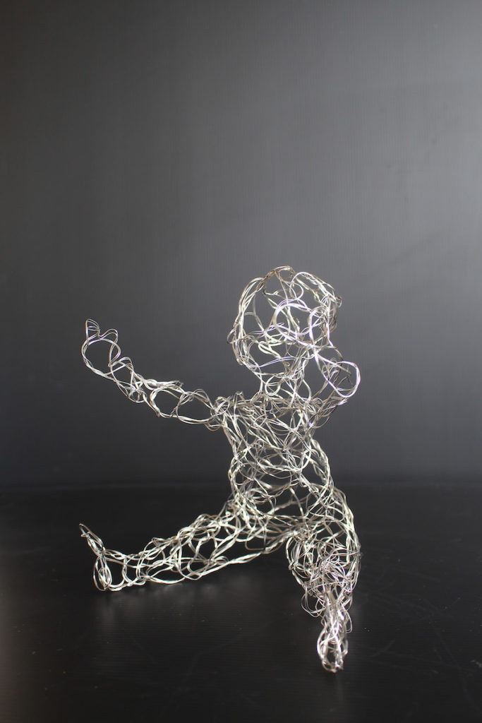 Stainless steel wire twisted into the form of a human baby. 