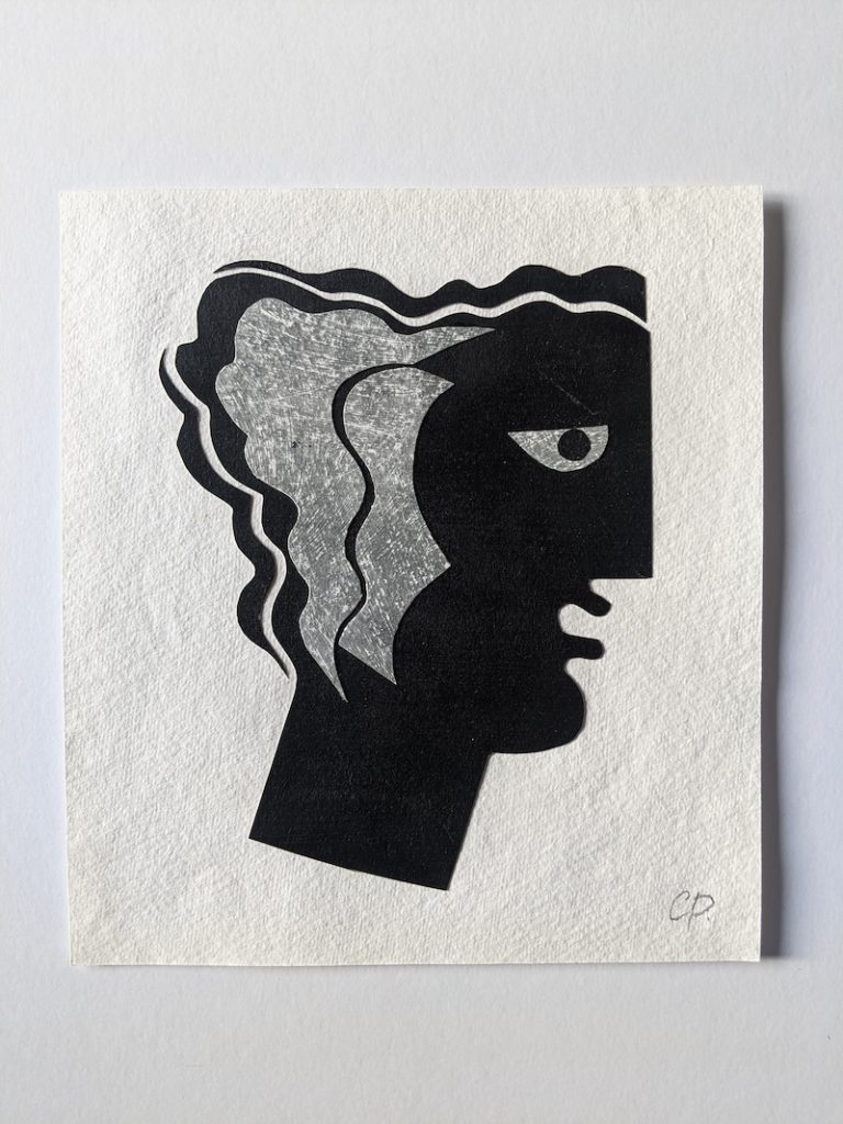 On textured paper, an abstract print of a face inspired by Grecian shapes and flowing lines. 