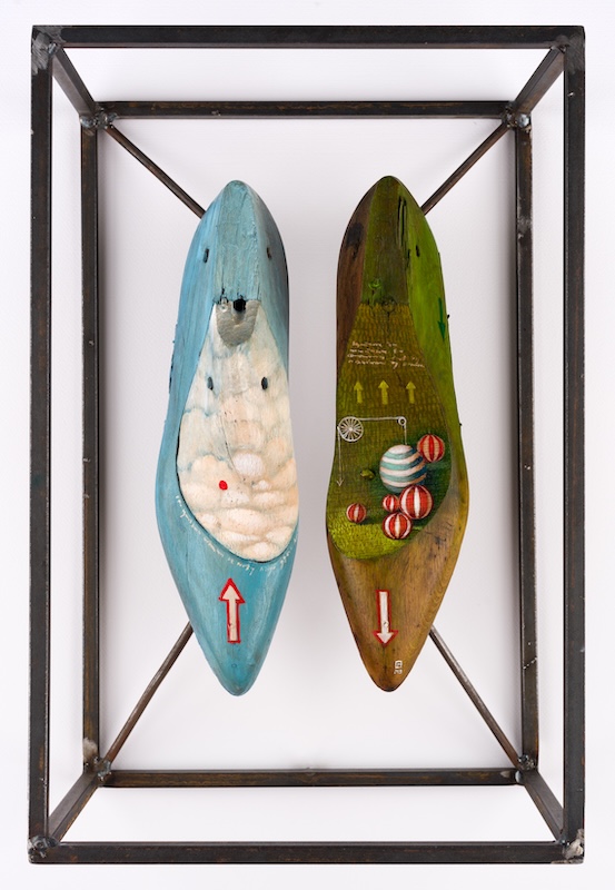 A surrealist sculpture of two wooden shoes. On the left, a red arrow points up. On the right, a red arrow points down. 