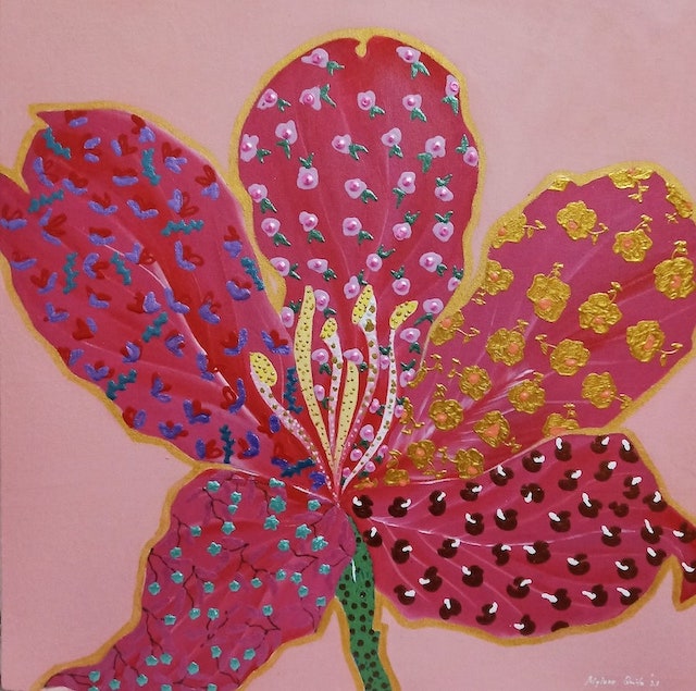 a big pink flower covered with yellow, blue, black, and green dots.