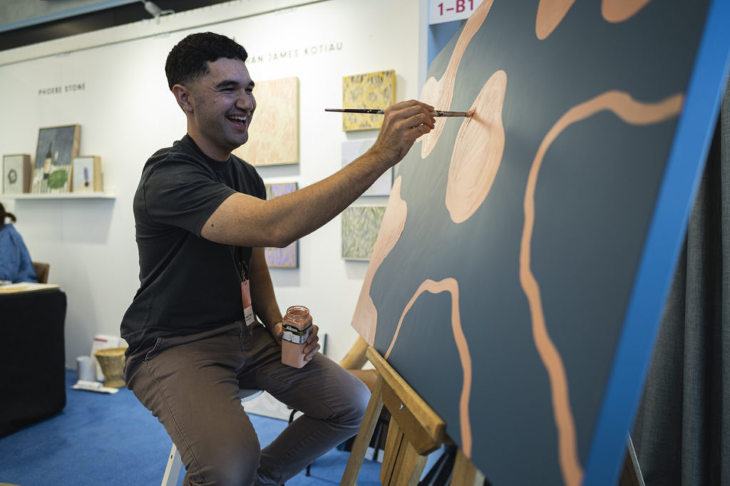 Ethan James Kotiau, Artist in Action, painting at Affordable Art Fair Sydney 2023.