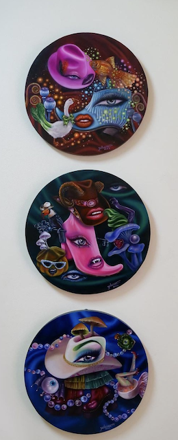 Three round paintings with eyes and mouth. 