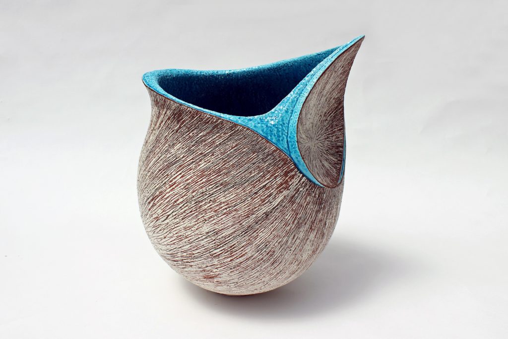 A shell-shaped ceramic work in brown with blue lining on top for the Year of the Dragon Feng Shui 